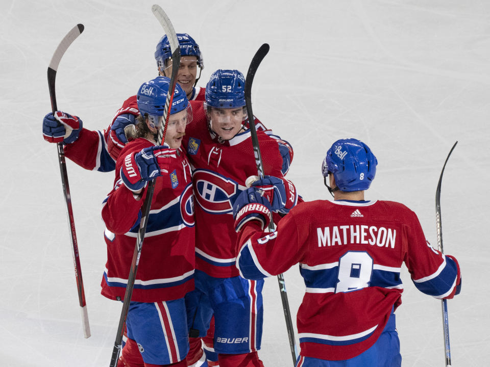 Montreal Canadiens' Justin Barron (52) celebrates his goal against the New Jersey Devils with Mike Matheson (8), Michael Pezzetta (55) and Jesse Ylonen (56) during the first period of an NHL hockey game Tuesday, Oct. 24. 2023, in Montreal. (Christinne Muschi/The Canadian Press via AP)