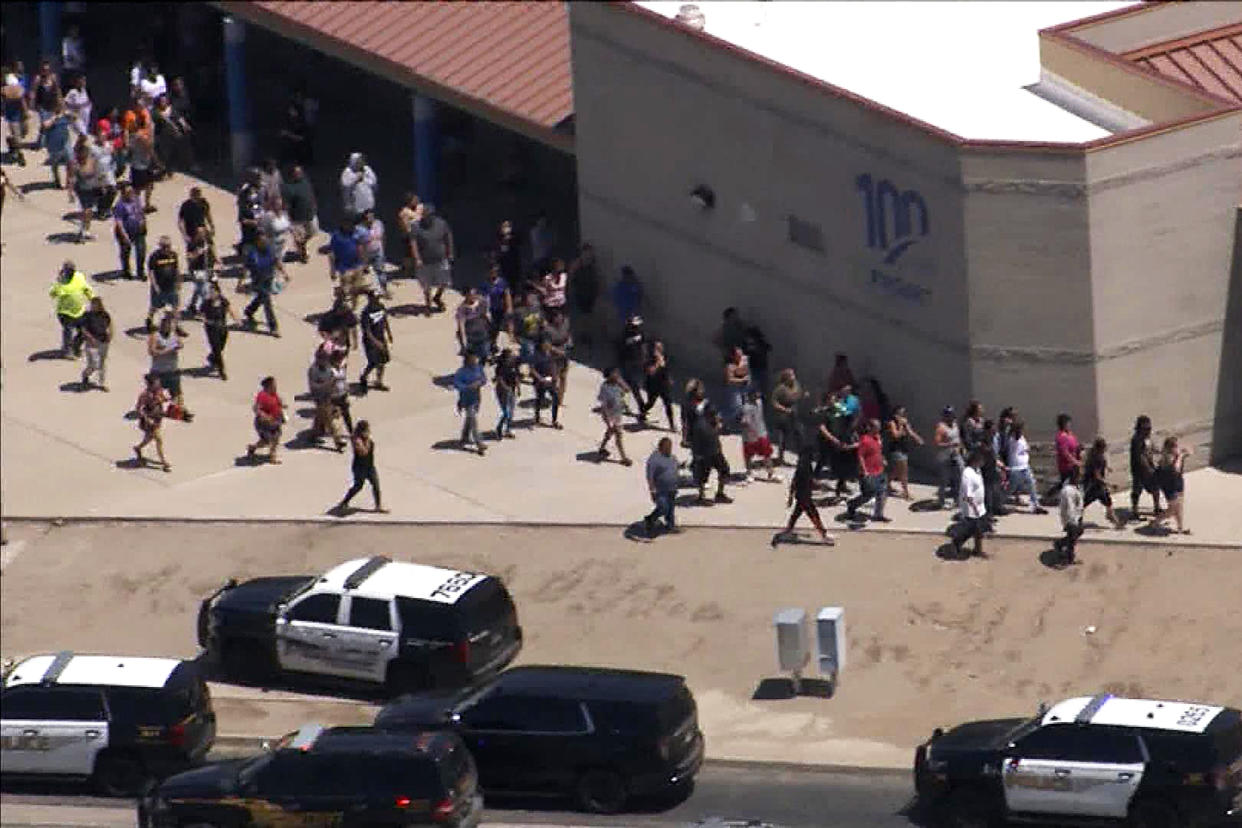 People walk outside the Thompson Ranch Elementary School during a school lockdown due to reports of a suspicious person on campus. (KPNX)