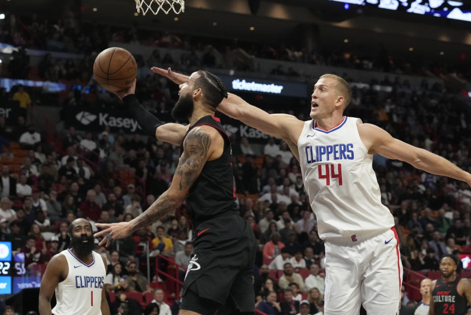 Miami Heat forward Caleb Martin (16) drives to the basket as LA Clippers center Mason Plumlee (44) defends during the first half of an NBA basketball game, Sunday, Feb. 4, 2024, in Miami. (AP Photo/Marta Lavandier)