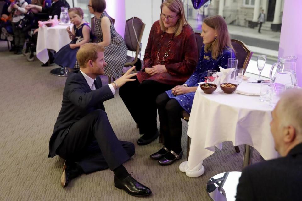 Prince Harry meets Sasha Burrell, aged 13, the winner of the Inspirational Child Award aged 11-14.(Getty Images)