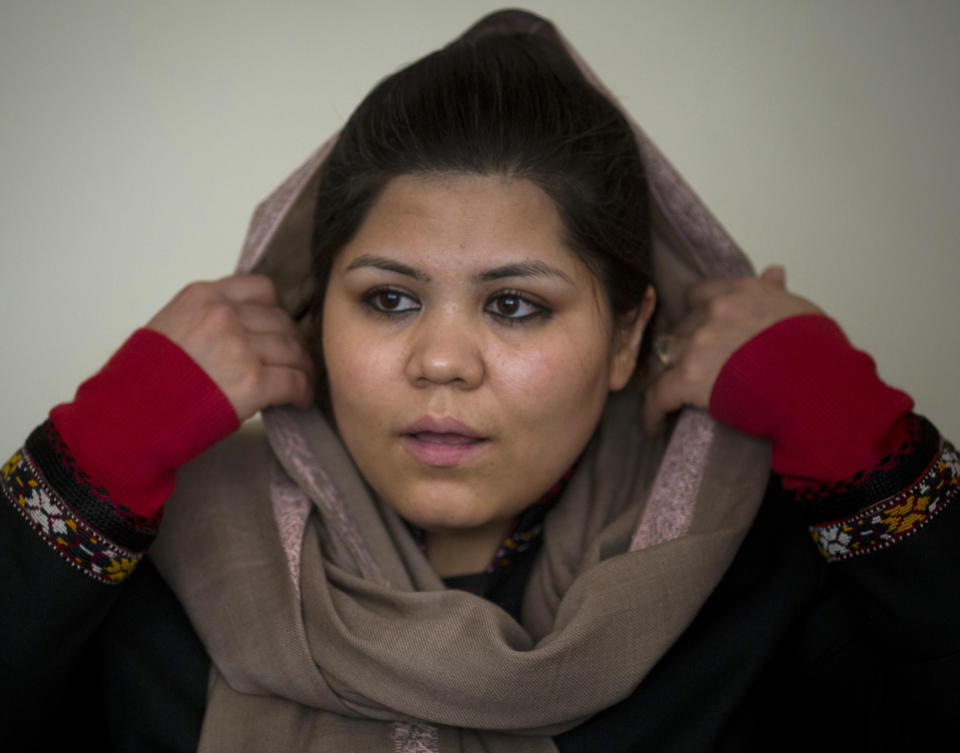 In this Wednesday, March 5, 2014 photo, prominent Afghan women’s rights activist Wazhma Frogh adjusts her scarf during an interview in her office in Kabul, Afghanistan. A gender and development specialist and human rights activist, Frogh says her experience characterizes the women’s rights movement in her country- after 12 years, billions of dollars and countless words emanating from the West commiserating with Afghan women, the successes are fragile, the changes superficial and vulnerable. (AP Photo/Anja Niedringhaus)