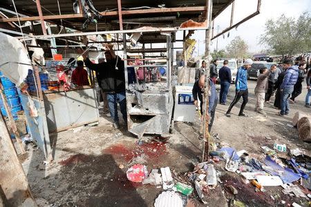 People look at wreckage at the site of car bomb attack in a busy square at Baghdad's sprawling Sadr City district, in Iraq January 2, 2017. REUTERS/Ahmed Saad