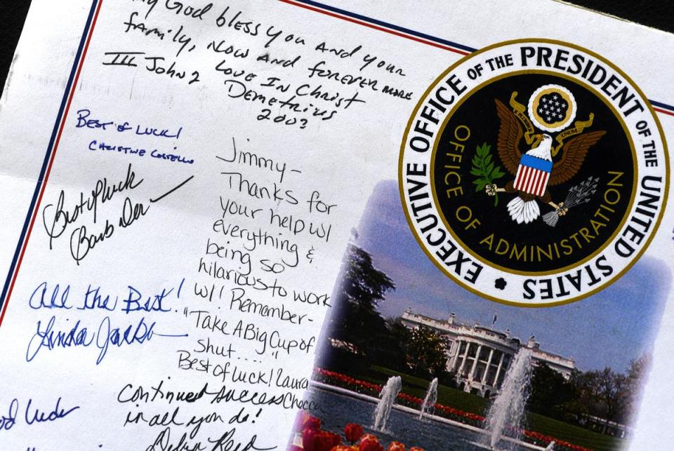 Coworkers express their appreciation of former U.S. Navy yeoman Jim Peckey from his time working in the White House. Peckey keeps these and other mementos of his government service at his home in Abilene.