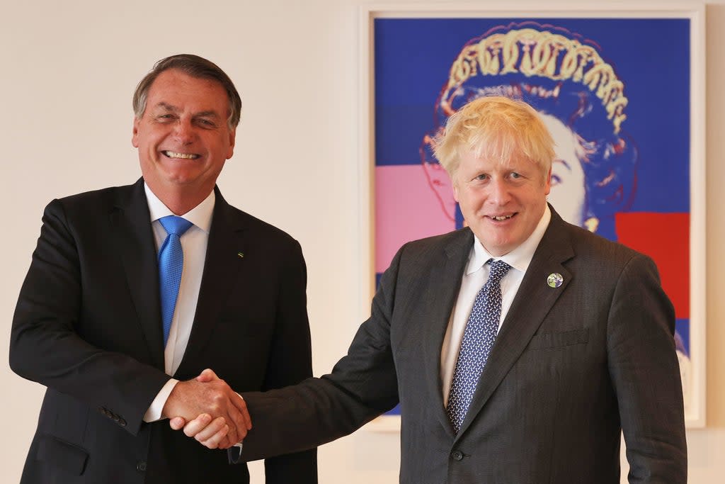 Boris Johnson shakes hands with Brazil’s president Jair Bolsonaro ahead of a bilateral meeting at the UK diplomatic residence in New York (PA)