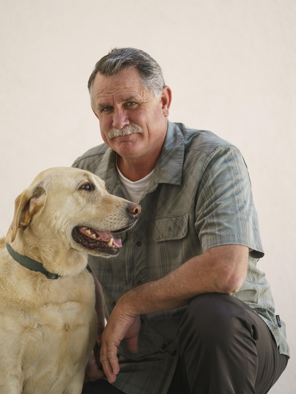 Orrin Heatlie, the main organizer for the Recall of California Gov. Newsom campaign, poses with his service dog Bailey after recording a radio program at the KABC radio station in Culver City, Calif., Saturday, March 27, 2021. (AP Photo/Damian Dovarganes)