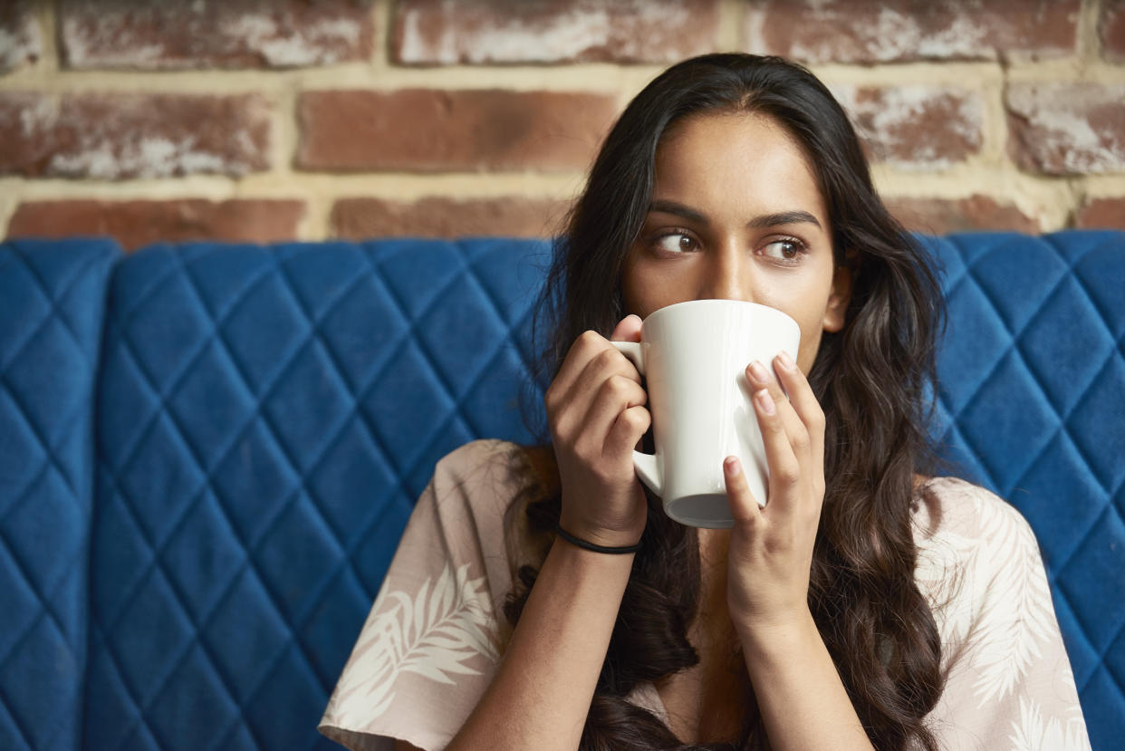 Young woman relaxing with a cup of coffee
