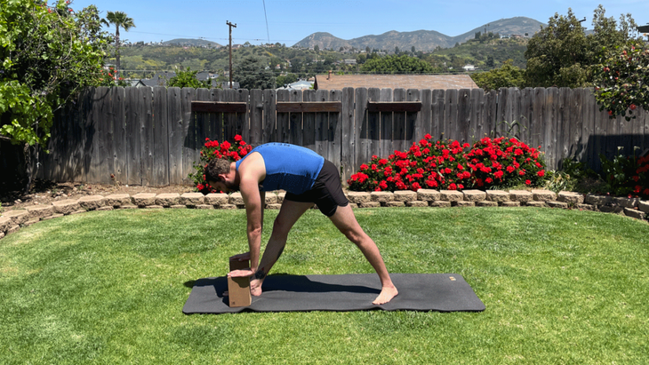 Man outside in his backyard practicing yoga for tall people
