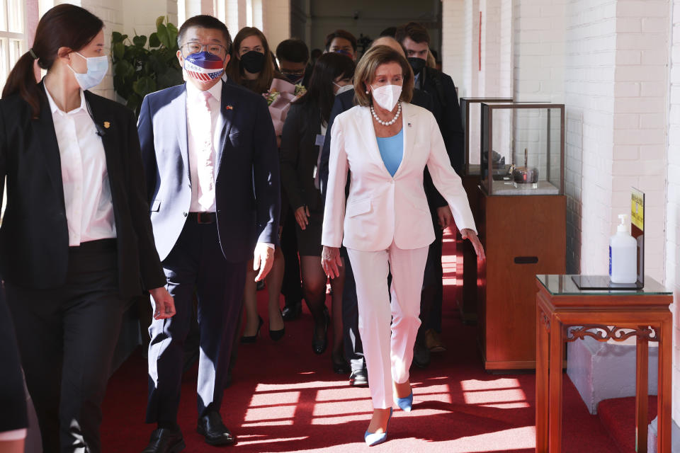 In this photo released by the Taiwan Legislative Yuan, U.S. House Speaker Nancy Pelosi, right, and Legislative Yuan Deputy Speaker Tsai Chi-chang arrive for a meeting in Taipei, Taiwan, Wednesday, Aug. 3, 2022. Pelosi, meeting top officials in Taiwan despite warnings from China, said Wednesday that she and other congressional leaders in a visiting delegation are showing they will not abandon their commitment to the self-governing island. (Taiwan Presidential Office via AP)