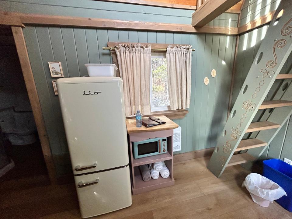 kitchenette  in Rapunzel's Cottage with large white fridge, microwave, and sink