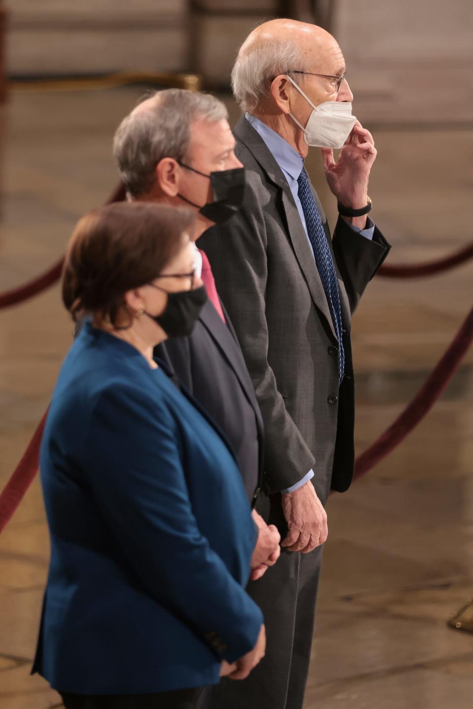 Associate Justice Elena Kagan, Chief Justice John Roberts, and Associate Justice Stephen Breyer pay their respects to former Sen. Bob Dole of Kansas, who lies in state in the Rotunda of the U.S. Capitol building on Dec. 9, 2021.