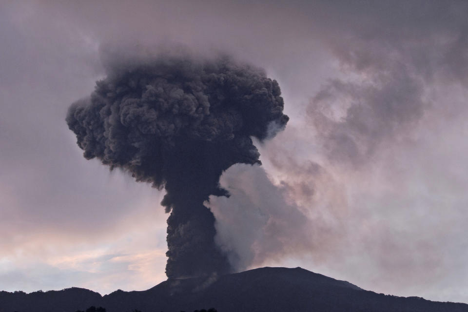 Mount Marapi spews volcanic material from its crater during an eruption in Agam, West Sumatra, Indonesia, Sunday, Jan. 14, 2024. Dozens of people living on the slopes of Mount Marapi have been evacuated from their homes after Indonesian authorities raised the alert level of of the nearly 2,900-meter (9,480-foot) volcano to the second highest as it continues to erupt. (AP Photo/Givo Alputra)