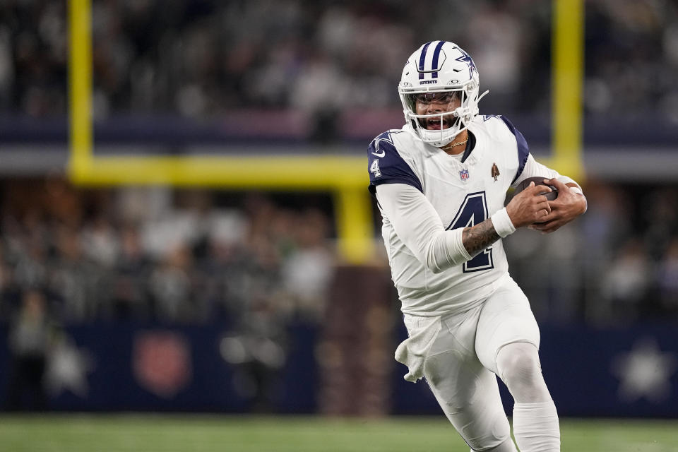 Dallas Cowboys quarterback Dak Prescott runs with the ball against the Philadelphia Eagles during the first half of an NFL football game, Sunday, Dec. 10, 2023, in Arlington, Texas. (AP Photo/Sam Hodde)