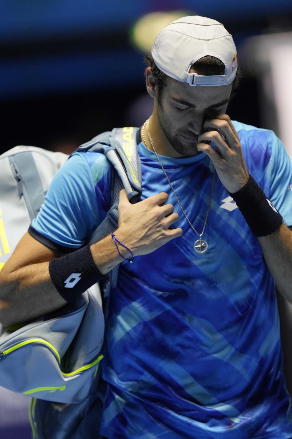 Italy's Matteo Berrettini leaves the playing field after he had an injury playing against Germany's Alexander Zverev during their ATP World Tour Finals singles tennis match, at the Pala Alpitour in Turin, Sunday, Nov. 14, 2021. (AP Photo/Luca Bruno)