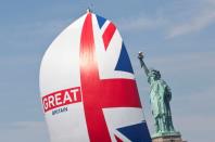 FILE PHOTO: A yacht from the Clipper Round The World race sails past the Statue of Liberty during a ceremonial parade in the Hudson River, New York.