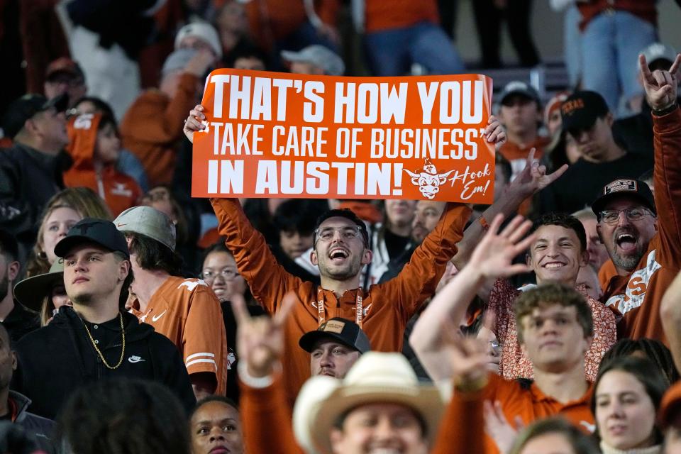 A Texas Longhorns fan holds up a sign after a victory over Texas Tech at Royal-Memorial Stadium in November. The Longhorns won the Big 12 in their final season in that conference; they join the SEC this summer.