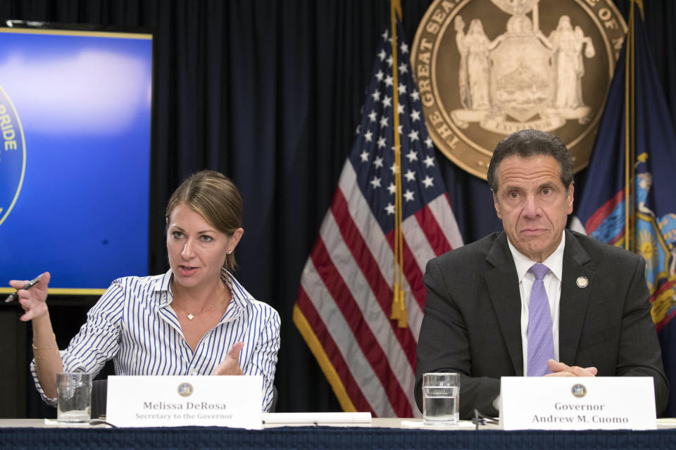 FILE — In this Sept. 14, 2018 file photo, Secretary to the Governor Melissa DeRosa, is joined by New York Gov. Andrew Cuomo as she speaks to reporters during a news conference, in New York. Top aides to Cuomo altered a state Health Department report to obscure the true number of people killed by COVID-19 in the state's nursing homes, The Wall Street Journal and The New York Times reported late Thursday, March 4, 2021. The aides, including DeRosa, pushed state health officials to edit the July report so only residents who died inside long-term care facilities, and not those who became ill there and later died at a hospital, were counted, the newspapers reported.(AP Photo/Mary Altaffer, File)