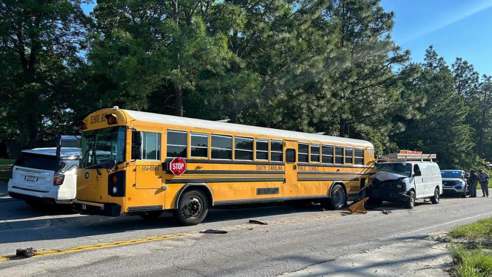 A school bus and work van were involved in a fatal crash with a motorcycle, police said.