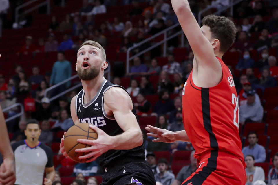 Sacramento Kings forward Domantas Sabonis, left, looks for a shot around Houston Rockets center Alperen Sengun during the first half of an NBA basketball game Wednesday, Feb. 8, 2023, in Houston. (AP Photo/Michael Wyke)