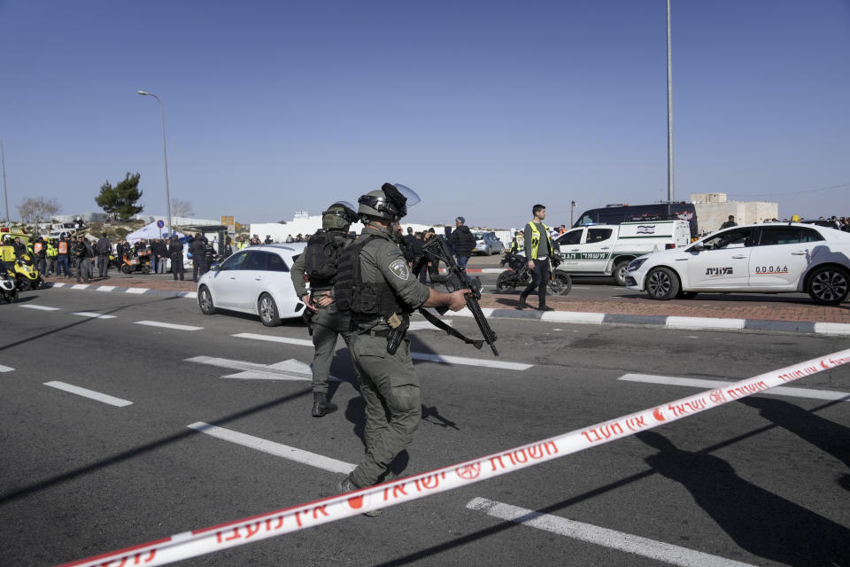 Israeli police secure the site of a car-ramming attack at a bus stop in Ramot, a Jewish settlement in east Jerusalem, Friday, Feb. 10, 2023. A suspected assailant rammed his car into several pedestrians in east Jerusalem on Friday. Police said that the suspected attacker was shot at the scene. There was no immediate word on his condition. Police identified the ages of the injured children as 5 and 6. (AP Photo/Mahmoud Illean)