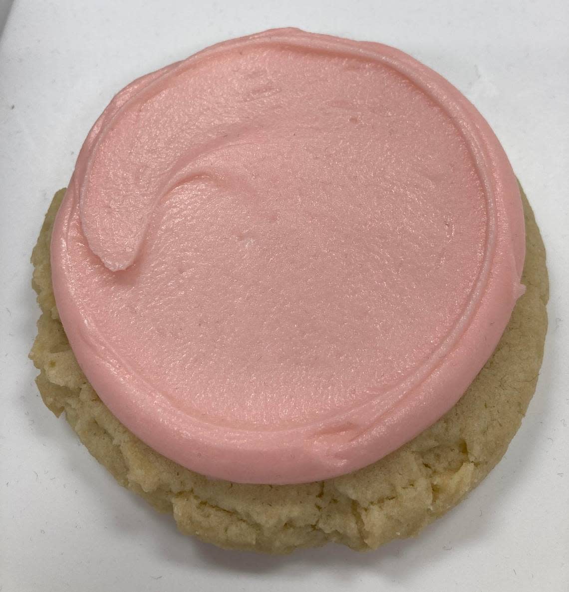 Classic pink sugar cookie at Crumbl Cookies in Warner Robins. The cookie is described as a vanilla sugar cookie topped with a pink swoop of almond frosting.