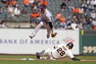 San Francisco Giants' Buster Posey is forced out at second base beneath Colorado Rockies shortstop Trevor Story on a fielder's choice hit by Mauricio Dubon during the fifth inning of a baseball game, Friday, April 9, 2021, in San Francisco. (AP Photo/Eric Risberg)