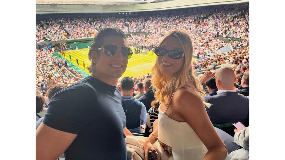 father and daughter watching tennis