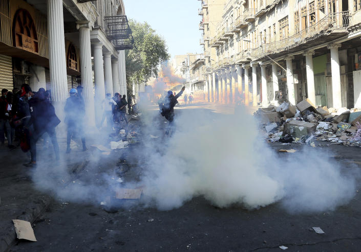 Riot police fire tear gas while blocking al-Rashid Street during clashes with anti-government demonstrators in Baghdad, Iraq, Nov. 22, 2019. (Photo: Hadi Mizban/AP)