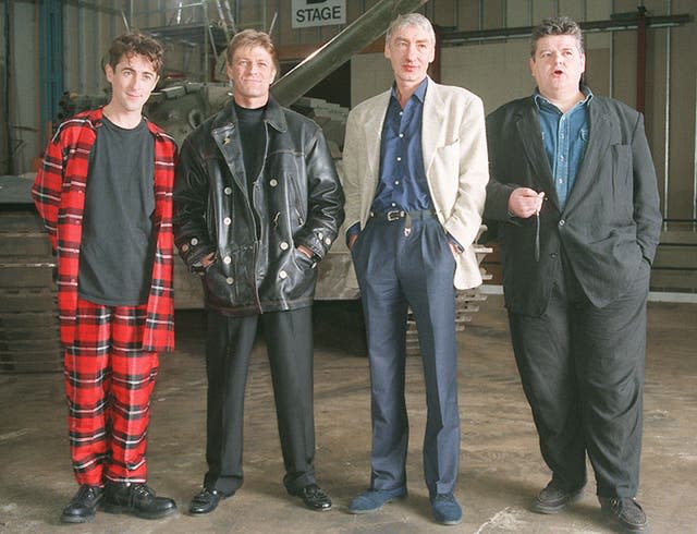 Villains of  the new James Bond film Goldeneye line up in front of a tank  during a photocall at Leavesden Airfield, Herts, on January 22 1995. L/R, Alan Cumming who is Boris,  Sean Bean who plays rouge agent 006, Alec Trevelyan,  Gottfried John who is Ourumov and Robbie  Coltrane who plays Valentin. Christmas 1995 is the projected world-wide release date for the 40 million thriller