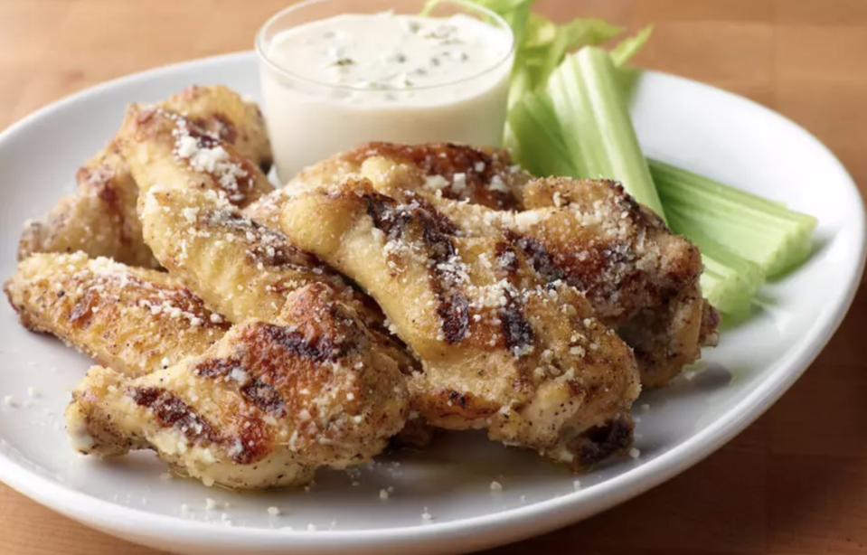 <p>These Parmesan garlic chicken wings are reminiscent of those found at the <a href="https://www.thedailymeal.com/best-sports-bar-every-state-america?referrer=yahoo&category=beauty_food&include_utm=1&utm_medium=referral&utm_source=yahoo&utm_campaign=feed" rel="nofollow noopener" target="_blank" data-ylk="slk:best sports bars;elm:context_link;itc:0;sec:content-canvas" class="link ">best sports bars</a>. </p> <p><a href="https://www.thedailymeal.com/best-recipes/grilled-wings-parmesan-garlic-sauce?referrer=yahoo&category=beauty_food&include_utm=1&utm_medium=referral&utm_source=yahoo&utm_campaign=feed" rel="nofollow noopener" target="_blank" data-ylk="slk:For the Grilled Parmesan Garlic Chicken Wings recipe, click here.;elm:context_link;itc:0;sec:content-canvas" class="link ">For the Grilled Parmesan Garlic Chicken Wings recipe, click here.</a></p>