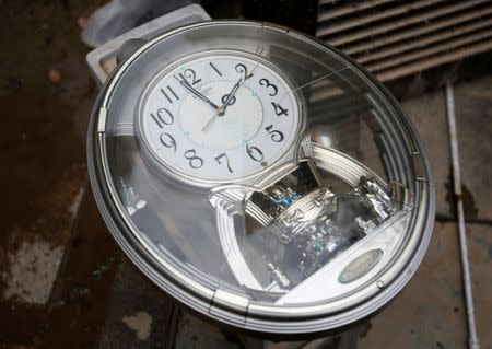 A broken clock is seen at the house of 79-year-old local resident Isao Akutagawa, in a flood affected area in Mabi town in Kurashiki, Okayama Prefecture, Japan, July 12, 2018. REUTERS/Issei Kato