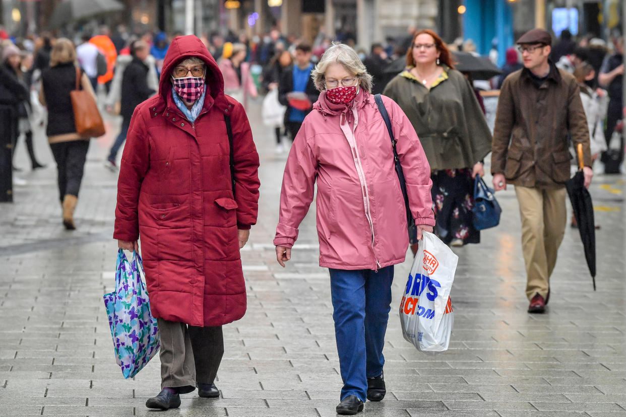 Shoppers wearing face masks carry bags in the centre of Cardiff where shops are open and people are out in numbers taking advantage of buying nonessential items in the run-up to Christmas. Restrictions across Wales have been relaxed following a two-week "firebreak" lockdown.