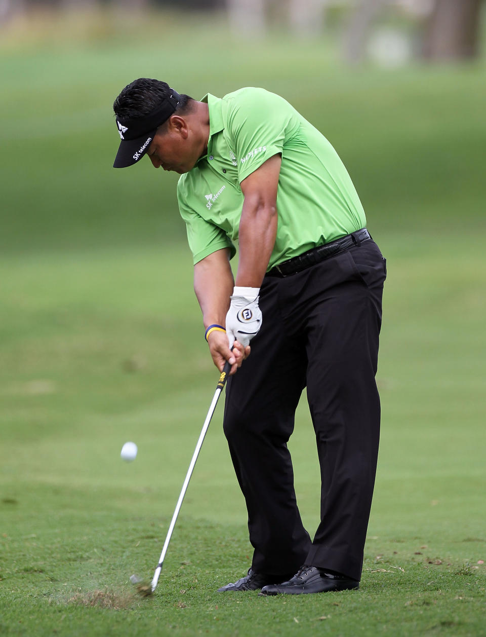 HONOLULU, HI - JANUARY 12: K.J. Choi of South Korea plays a shot on the 15th hole during the first round of the Sony Open at Waialae Country Club on January 12, 2012 in Honolulu, Hawaii. (Photo by Sam Greenwood/Getty Images)