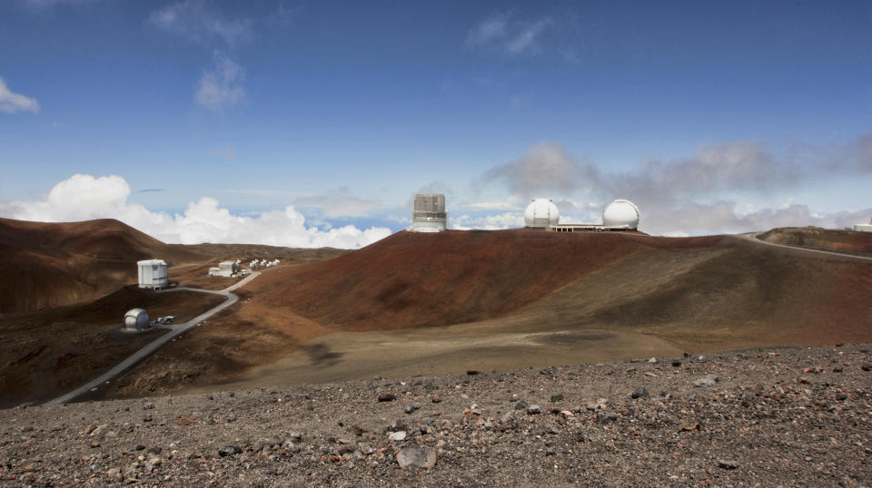 FILE - Telescopes are seen on the summit of Mauna Kea on Hawaii's Big Island, on Aug. 31, 2015. The National Science Foundation said Tuesday, July 19, 2022, that it plans to conduct a study to evaluate the environmental effects of building the Thirty Meter Telescope, one of the world's largest optical telescopes, on sites selected on Mauna Kea in Hawaii and Spain's Canary Islands. (AP Photo/Caleb Jones, File)