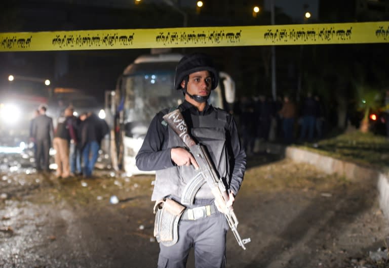 A member of the Egyptian security forces stands guard at the scene of an attack on a tourist bus in Giza province south of the Egyptian capital Cairo on December 28, 2018