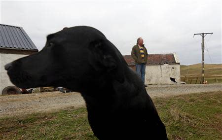 Ian Tomkinson, 57, poses for a photograph beside his house near the village of Sandness on the Shetland Islands April 1, 2014. REUTERS/Cathal McNaughton