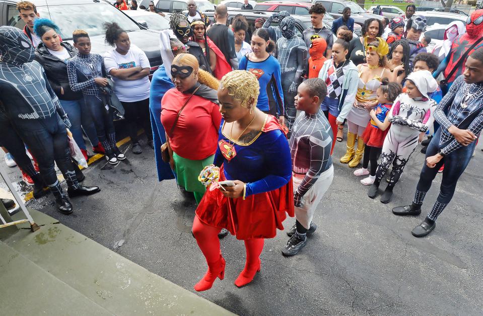 Raquel Coleman, center, mother of 7-year-old homicide victim Antonio Yarger Jr., leads mourners into the funeral service for her son inside Second Baptist Church in Erie on April 23, 2022.