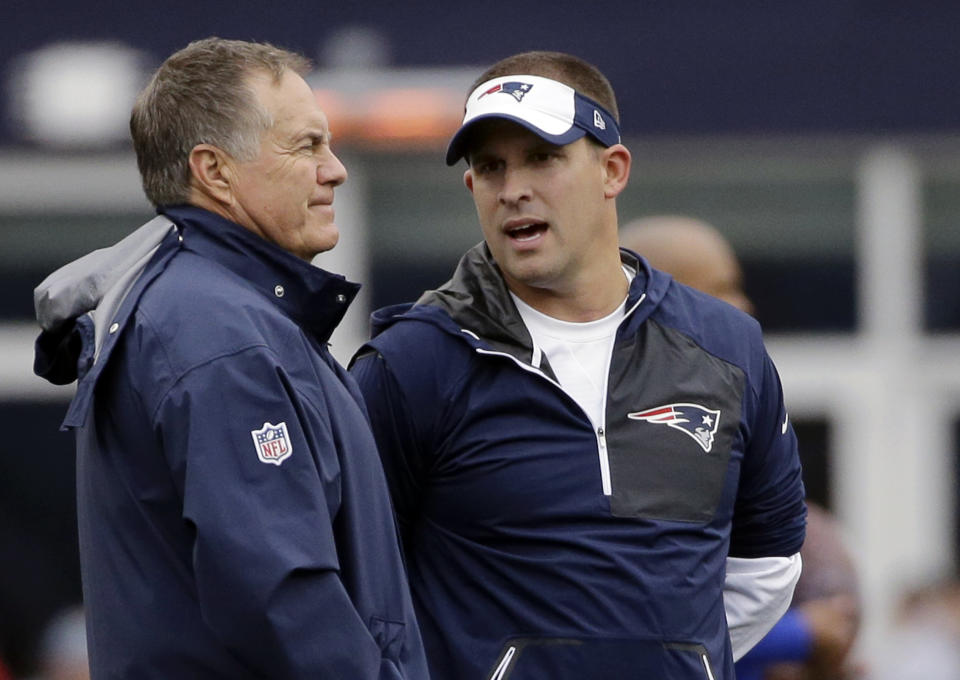 New England Patriots head coach Bill Belichick, left, and offensive coordinator Josh McDaniels talk before a game. (AP)