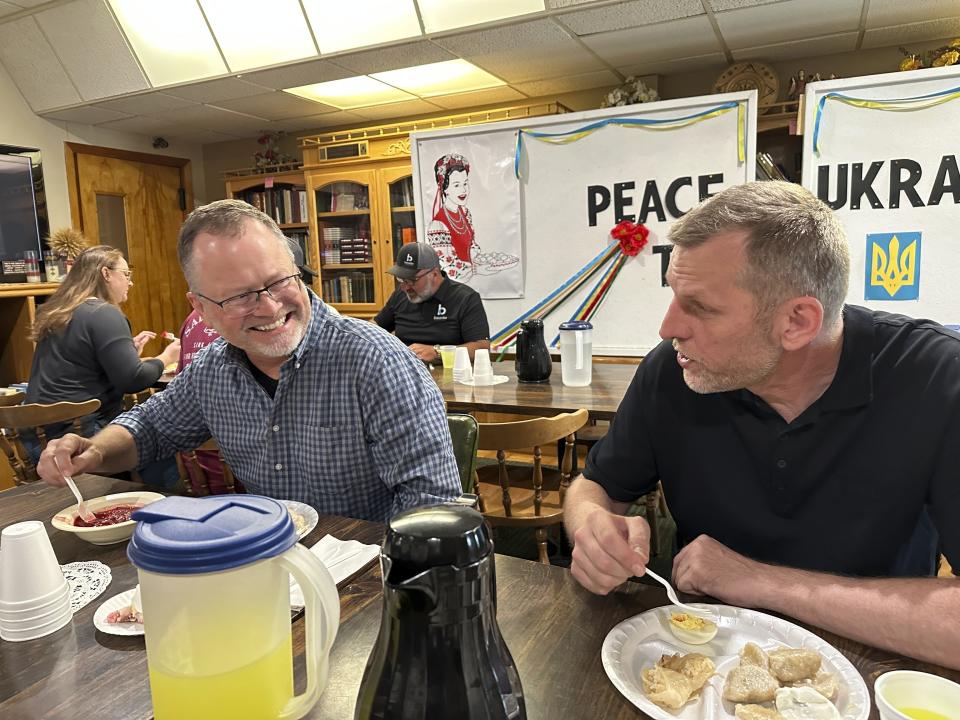 Bakken GROW Project Manager Brent Sanford and Vladydlav Veselov converse during a lunch hosted Monday, July 17, 2023, by the Ukrainian Cultural Institute in Dickinson, N.D. The North Dakota Petroleum Council's Bakken Global Recruitment of Oilfield Workers program placed about 60 Ukrainians with 16 employers throughout western North Dakota from July to November 2023, Council President Ron Ness said. The group shelved the program due to lack of demand from companies, he said. (AP Photo/Jack Dura, File)