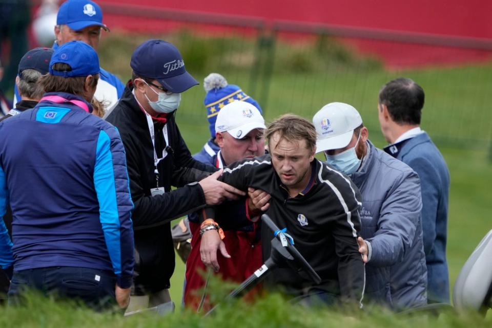 Tom Felton is helped after collapsing on the 18th hole during a practice day at the 2021 Ryder Cup (AP)