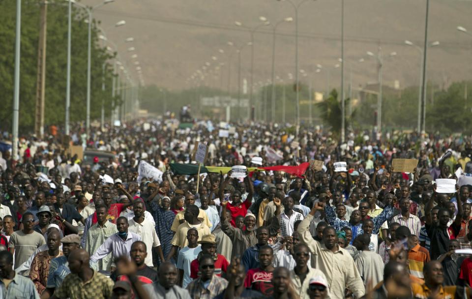 People march along a central street as thousands rallied in a show of support for the recent military coup, in Bamako, Mali Wednesday, March 28, 2012. The body representing nations in western Africa has suspended Mali and has put a peacekeeping force on standby in the most direct threat yet to the junta that seized control of this nation in a coup last week.(AP Photo/Rebecca Blackwell)
