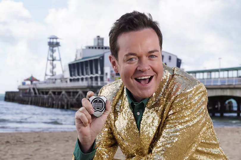 Stephen Mulhern posing on an In For A Penny table top