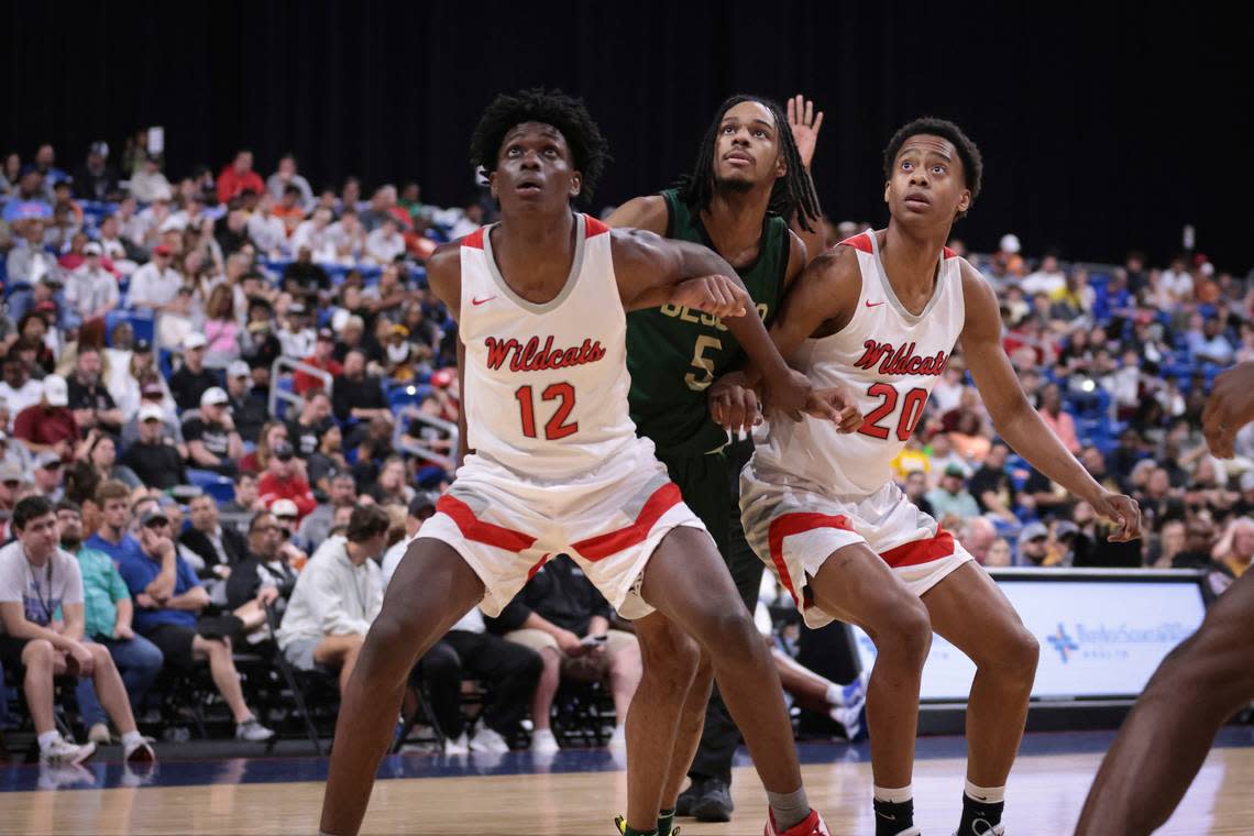 Lake Highlands’ Jaire Williams (12), left, and Tre Johnson (20), right, box out DeSoto’s Ahmir Wall in a Class 6A state semifinal on Friday, March 10, 2023, at the Alamodome in San Antonio, Texas.