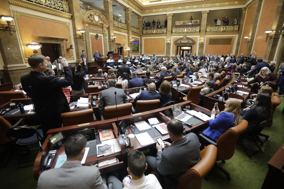 FILE - In this Jan. 27, 2020, file photo, lawmakers conduct business on the floor of the Utah House of Representatives in Salt Lake City. The Utah Legislature is wrapping up its work for the year, capping off a session that saw major changes to the state's polygamy statute, a revision of a voter-approved redistricting law and a compromise on education funding. The 45-day meeting is ending in the shadow of the new coronavirus, which caused widespread cancellations but didn't cause major disruptions in legislative business. (AP Photo/Rick Bowmer, File)