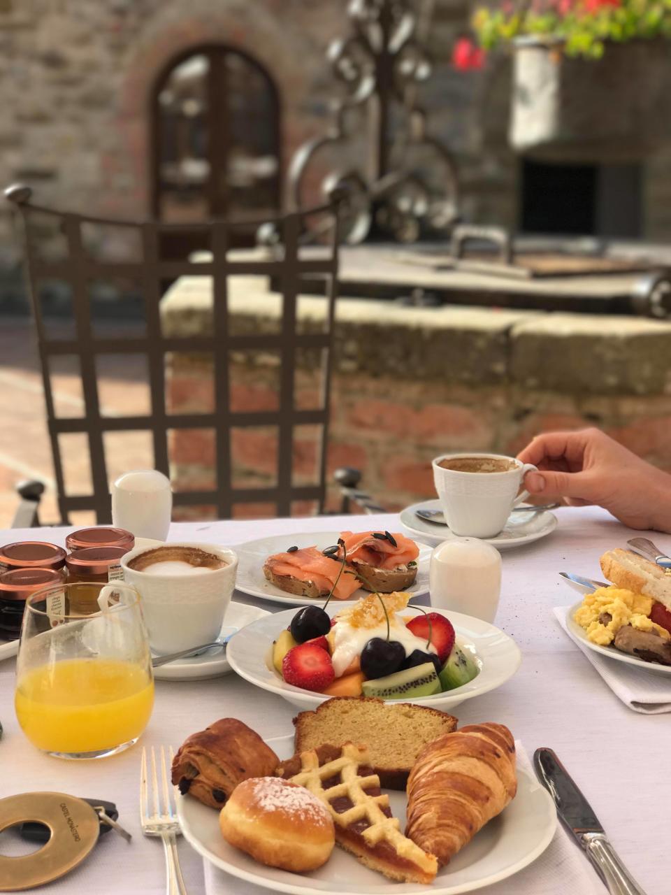 A medieval castle square is the breakfast setting at Castel Monastero. Serving 10th century vibes indeed. Photo: Yahoo Australia