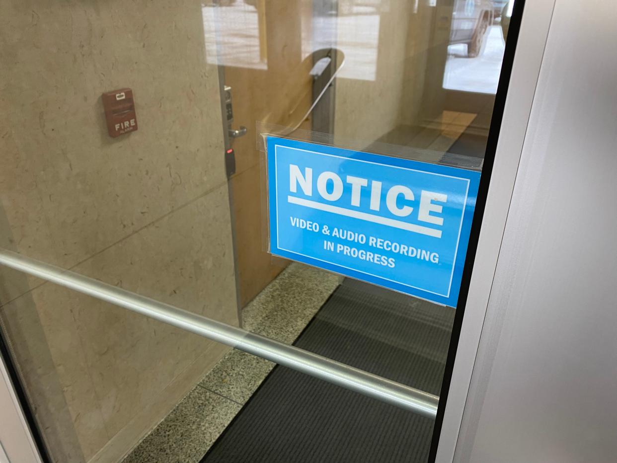 A sign in February at the parking lot entrance to Green Bay City Hall warns people that they may be photographed or recorded by cameras and microphones inside the building.