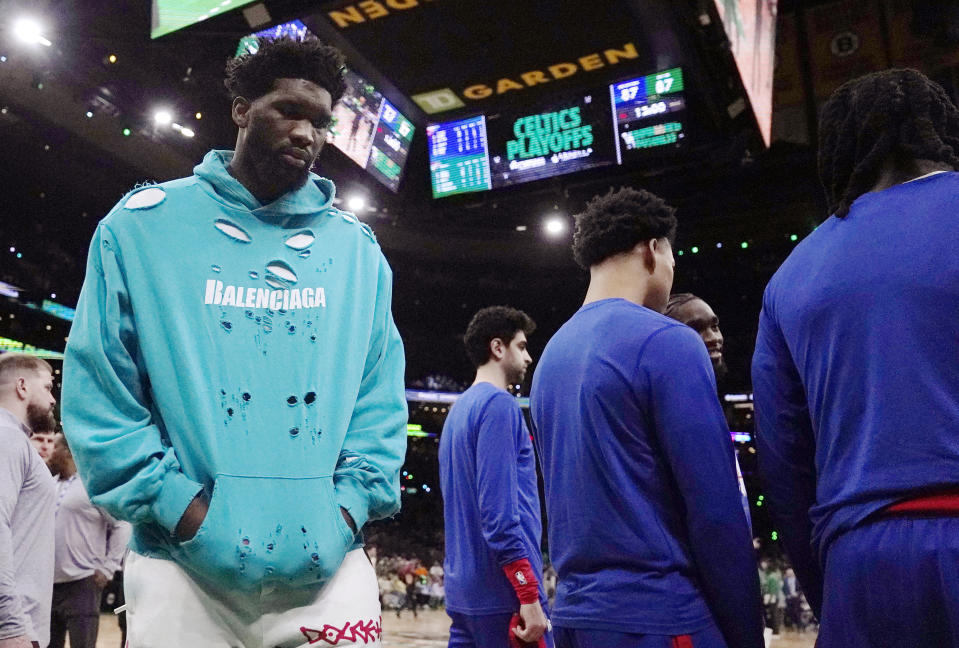 Philadelphia 76ers center Joel Embiid, left, walks on the court during the beginning of the second half of Game 1 against the Boston Celtics in the NBA basketball Eastern Conference semifinals playoff series, Monday, May 1, 2023, in Boston. (AP Photo/Charles Krupa)