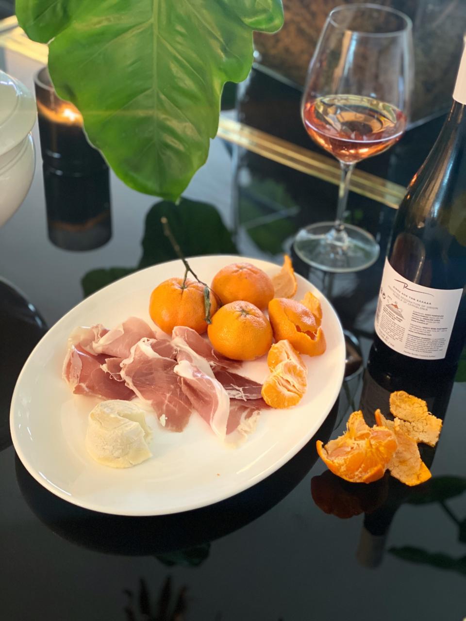 Charcuterie, wine, and clementines.