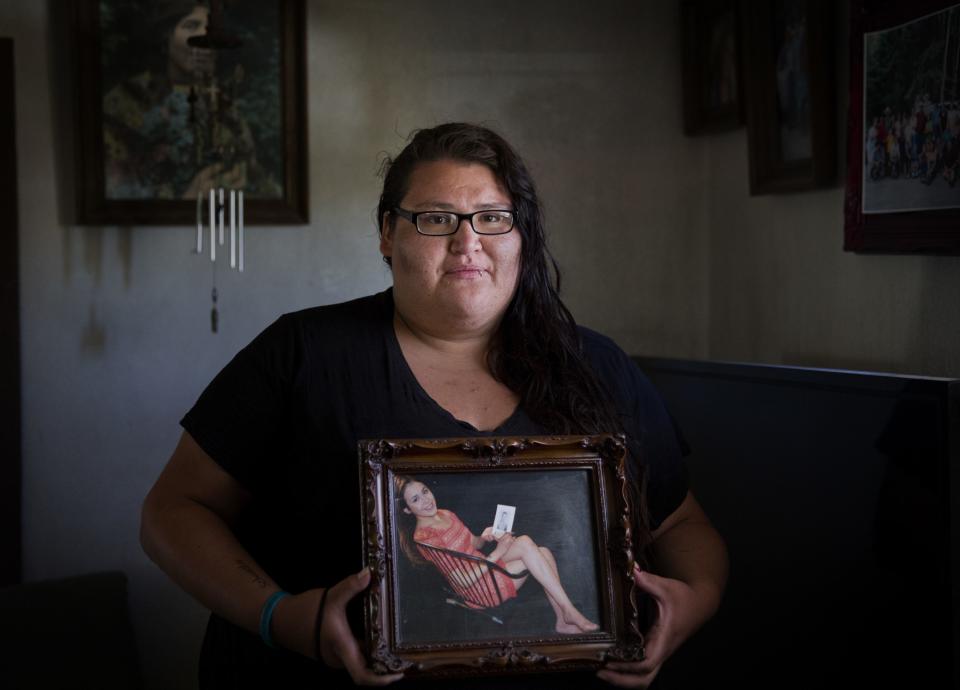 In this July 13, 2018, file photo, Kimberly Loring stands in her grandmother’s home in Browning, Mont., holding a photo of her sister, Ashley Loring HeavyRunner, who went missing on the Blackfeet Indian Reservation in 2017. Native Americans go missing and are killed at disproportionately high rates nationwide. | David Goldman, Associated Press