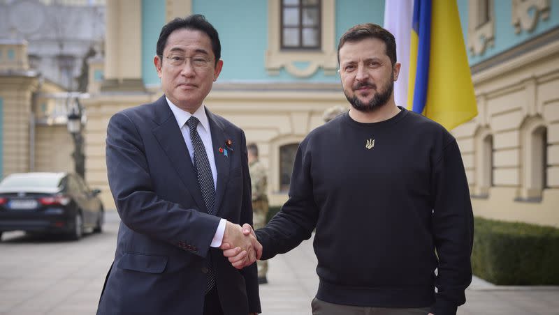 Japanese Prime Minister Fumio Kishida, left, and Ukrainian President Volodymyr Zelenskyy, right, greet each other during their meeting in Kyiv, Ukraine, March 21, 2023. Zelenskyy will join leaders of the world’s most powerful democracies in Hiroshima, Japan, making his furthest trip from of his war-torn country as leaders are set to unveil new sanctions on Russia for its invasion.