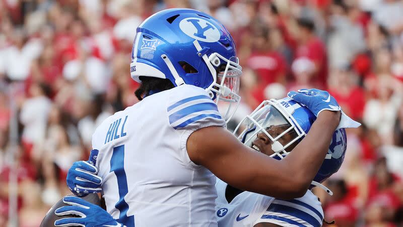 BYU's Keanu Hill (1) celebrates a touchdown with running back Deion Smith (20) against the Arkansas Razorbacks at Razorback Stadium in Fayetteville on Saturday, Sept. 16, 2023.